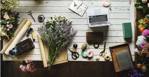 Florist workbench with laptop, flowers, and tools—small business using email marketing software